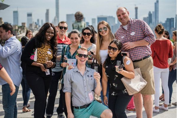 group posed in front of a city skyline while wearing sunglasses