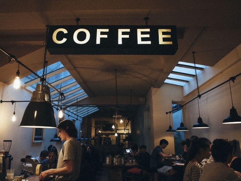 A picture of people working in a trendy coffee shop